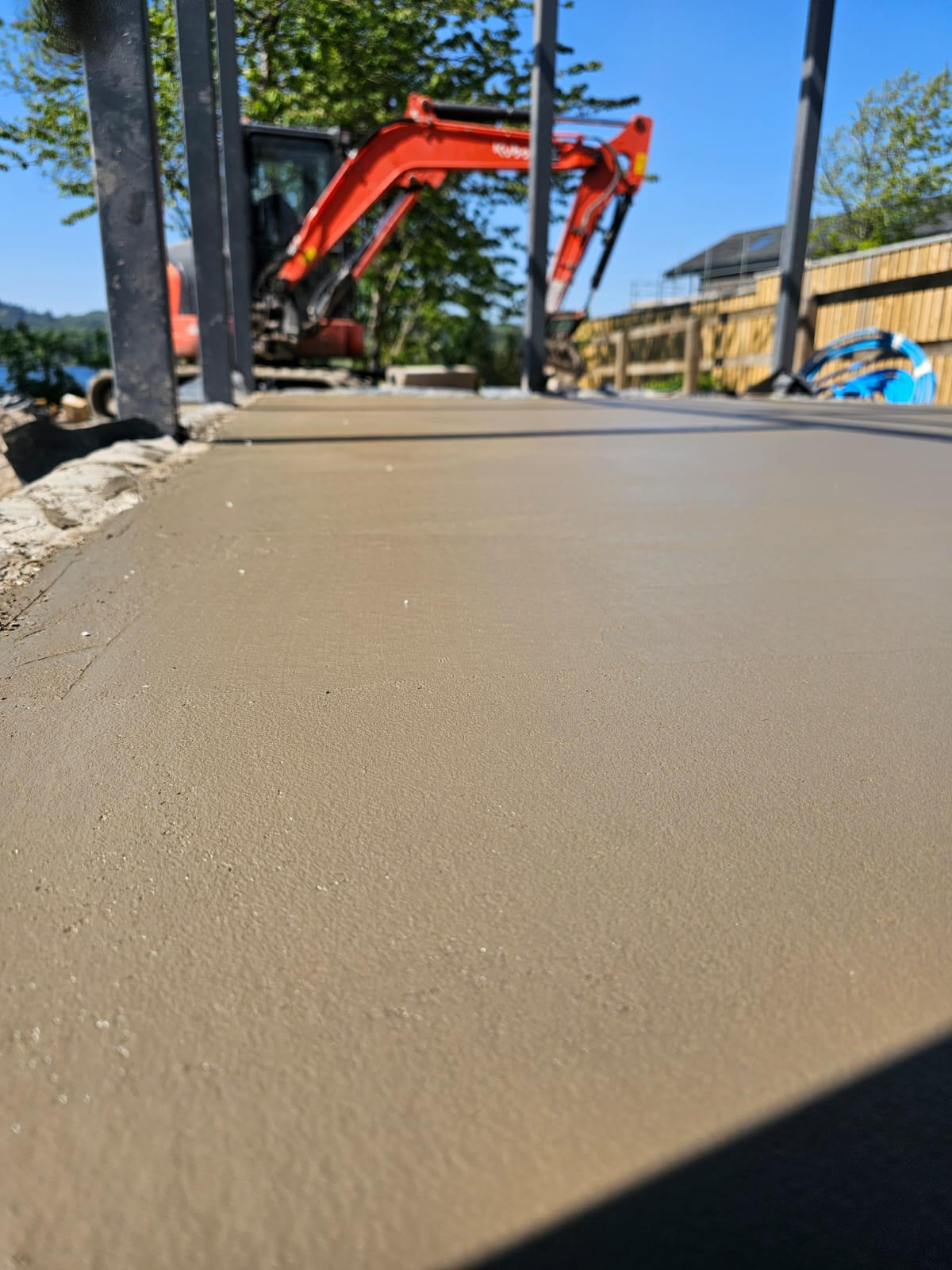 Power-floated concrete slab close-up under steel frame