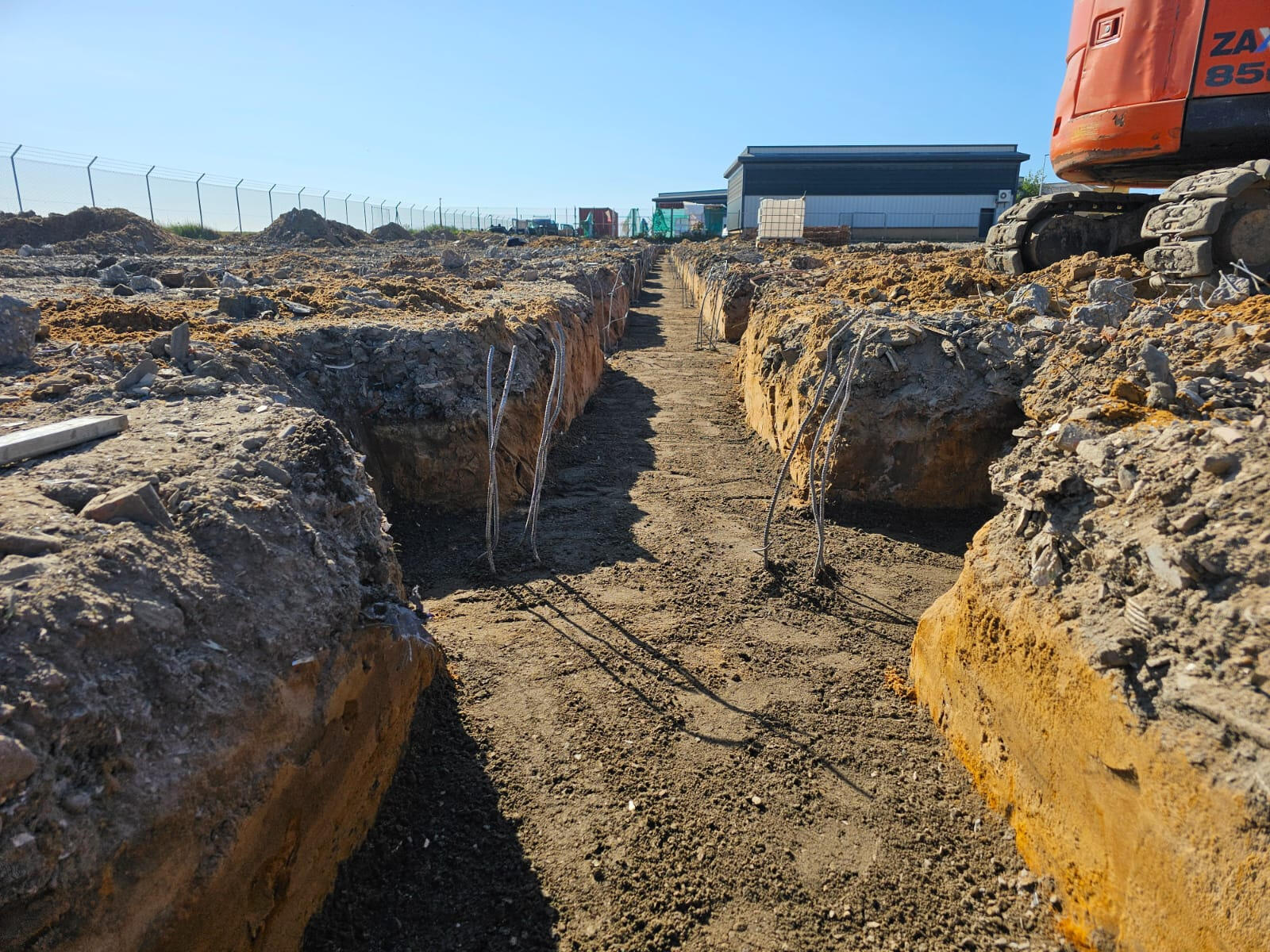 Strip foundation trenches with rebar starters on a commercial site