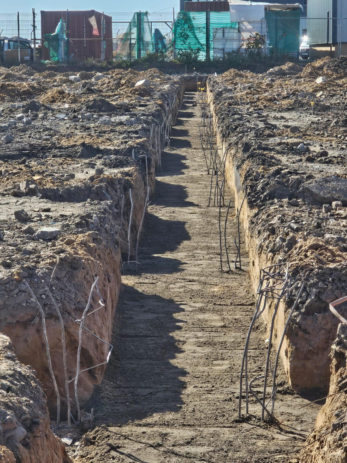 Deep reinforced strip trenches with vertical starter bars projecting