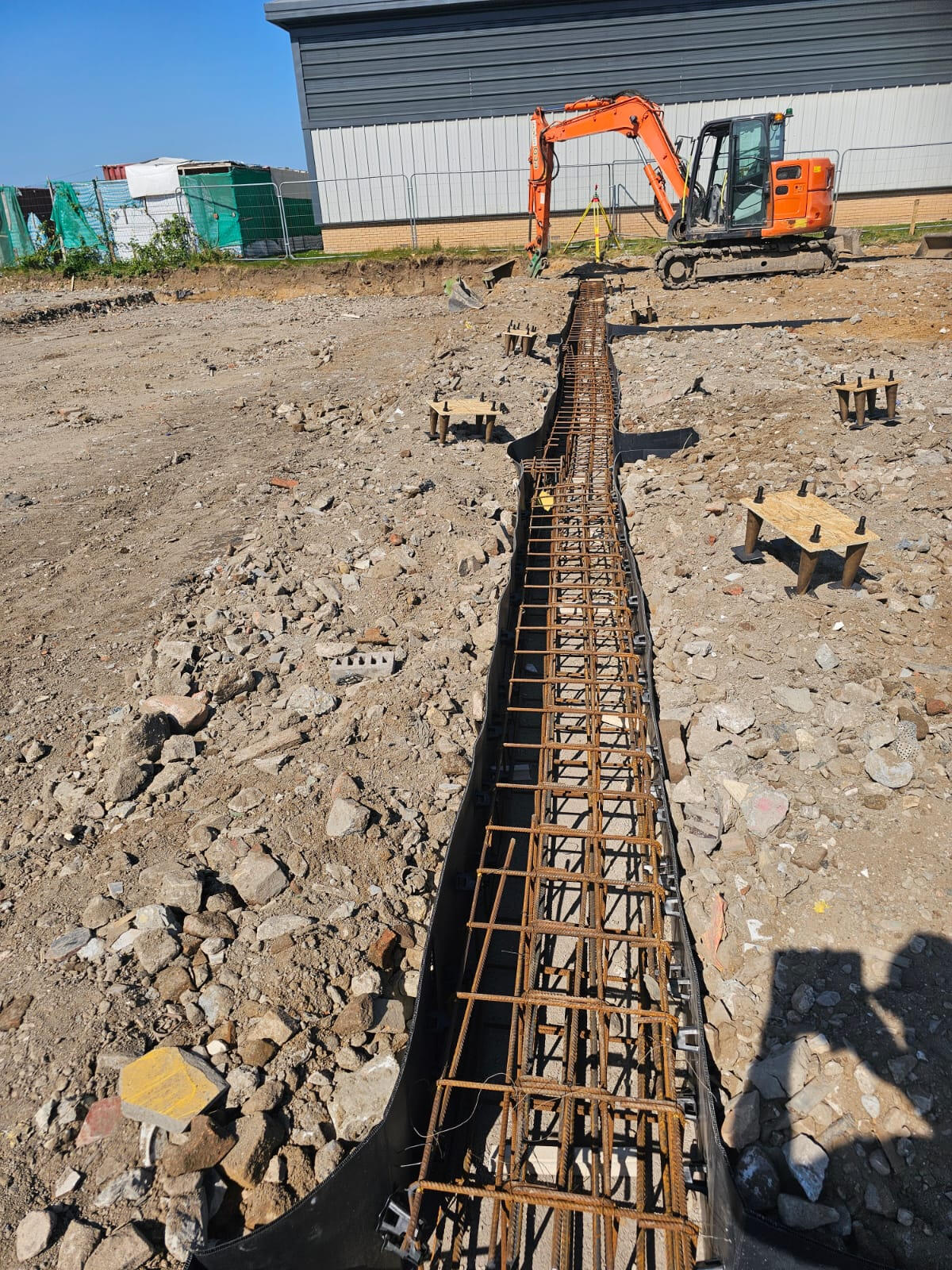 Reinforced strip foundation with rebar cage on a commercial site