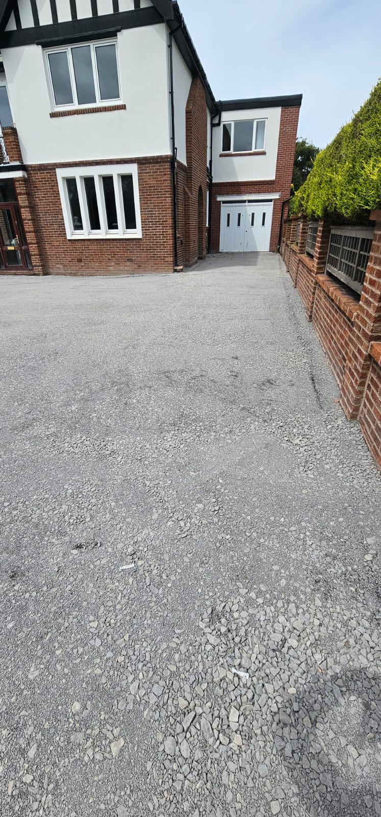 Freshly laid driveway running up to the side of a house