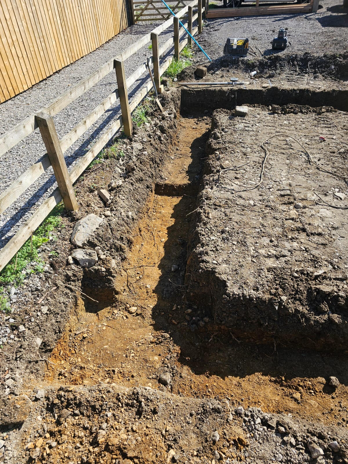 Hand-trimmed strip foundation trench dug along the perimeter of the slab