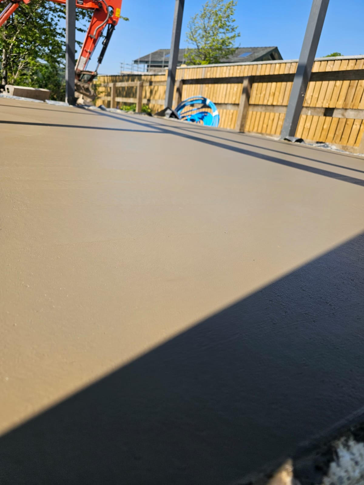 Smooth-finish concrete surface under steel posts