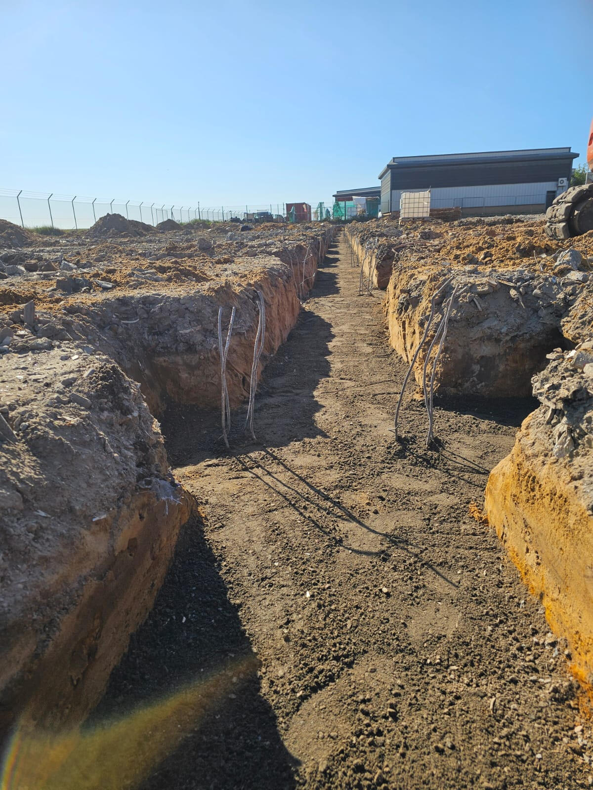 Excavated commercial strip footing trenches with rebar starter bars