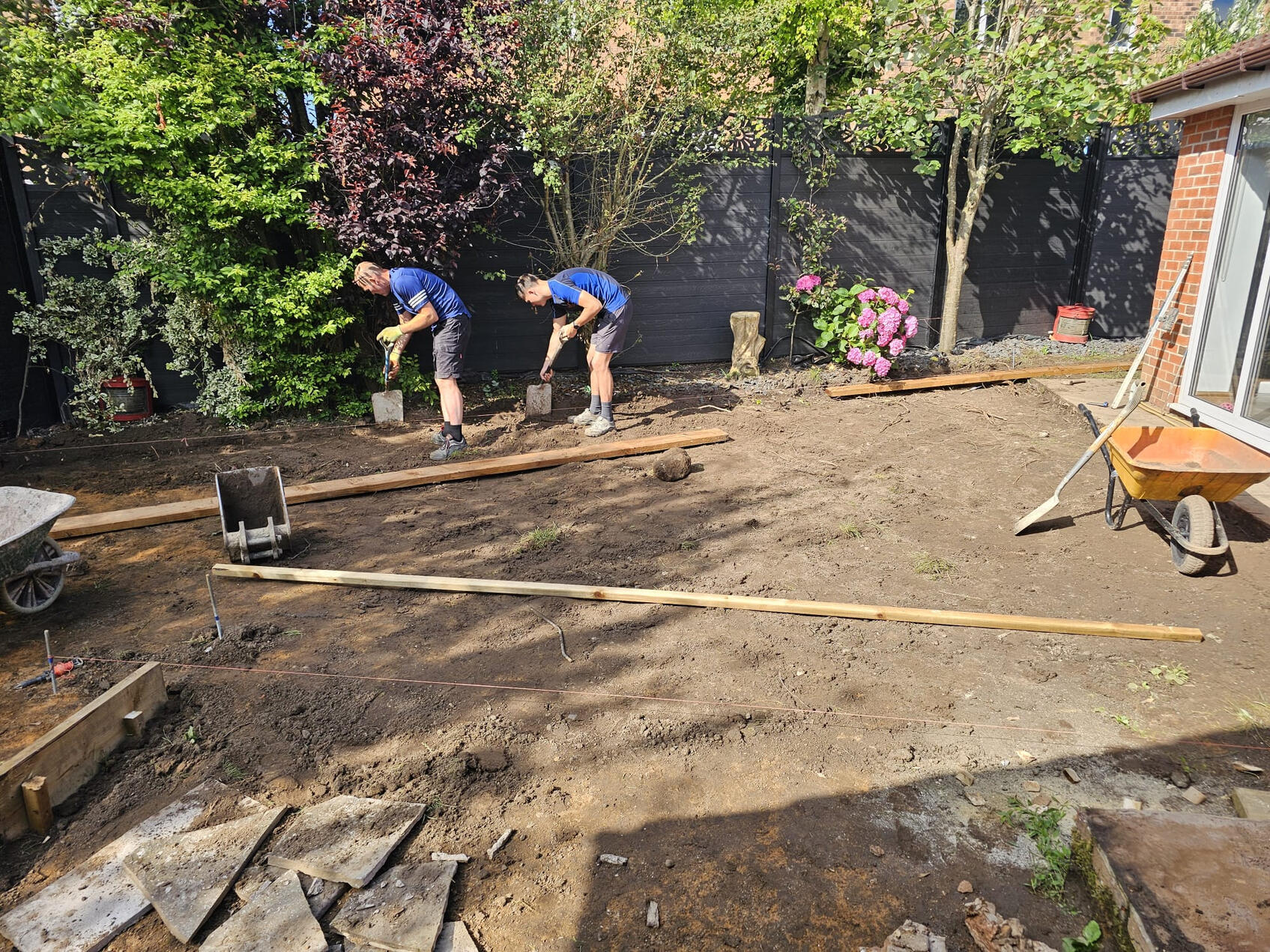 DSG team setting levels and string lines across the garden during dig-out