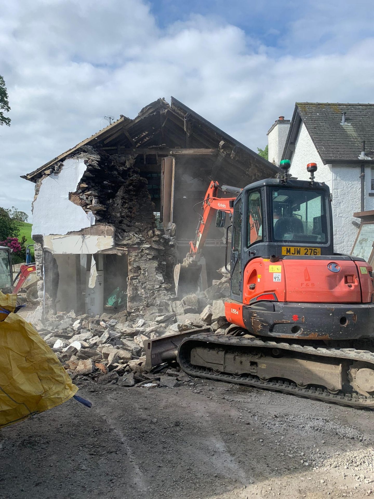 Controlled demolition of a stone cottage with Kubota excavator